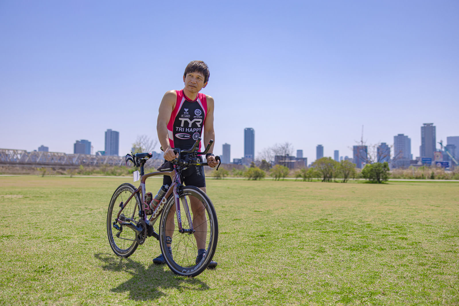 Triathlete with a road bike on the grass